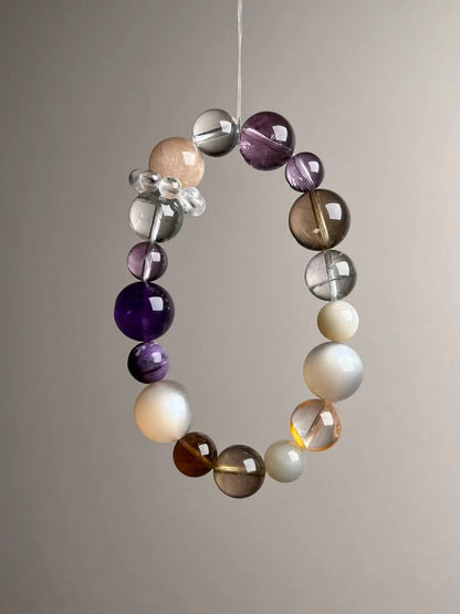 Detail—Clear Quartz bead-cluster spacer next to Orange Moonstone and Auralite-23 beads