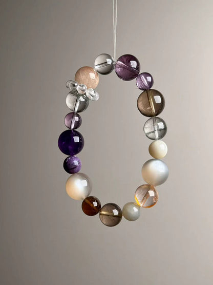 Front hero—Aurora Abundance Matrix bracelet showing Orange Moonstone glow, Auralite-23 purples and golden rutile needles, 14.5–9 mm.