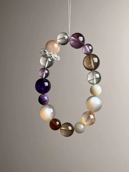 Front hero—Aurora Abundance Matrix bracelet showing Orange Moonstone glow, Auralite-23 purples and golden rutile needles, 14.5–9 mm.