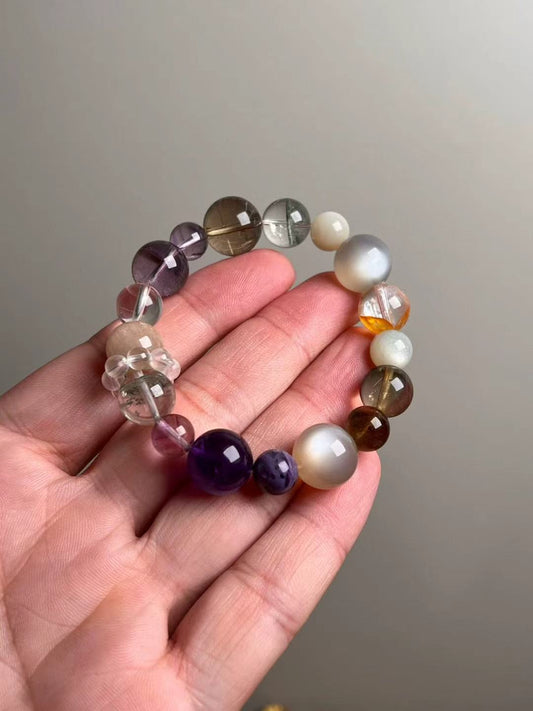 On-hand photo—14.5–9 mm bracelet with Orange Moonstone, Auralite-23, Golden Rutilated Quartz, White Moonstone and Clear Quartz bead-cluster spacer