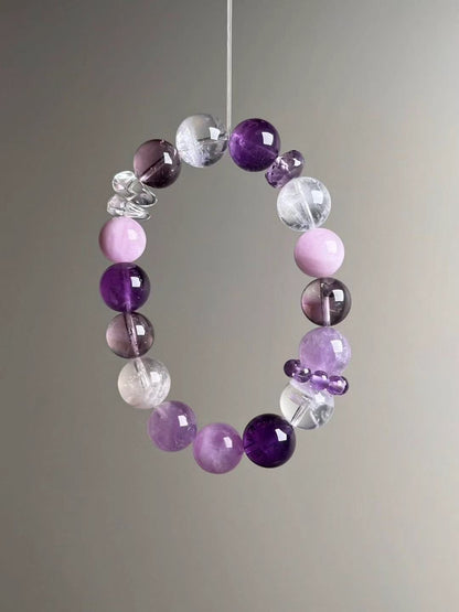 Angled hero—balanced purples and clear tones; textured Clear Quartz spacer and Lepidolite accents