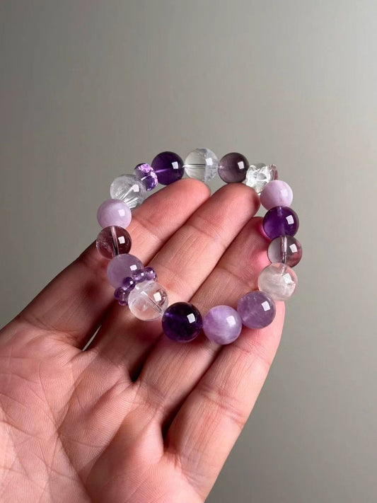 On-hand photo—12.5–11.5 mm Amethyst, White Phantom, Clear Quartz and Lepidolite bracelet with purple bead-cluster spacer