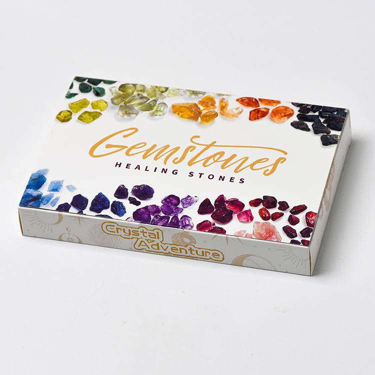 Top view of the Gemstones Healing Stones DIY jewelry advent box—rainbow crystal roughs on white packaging.