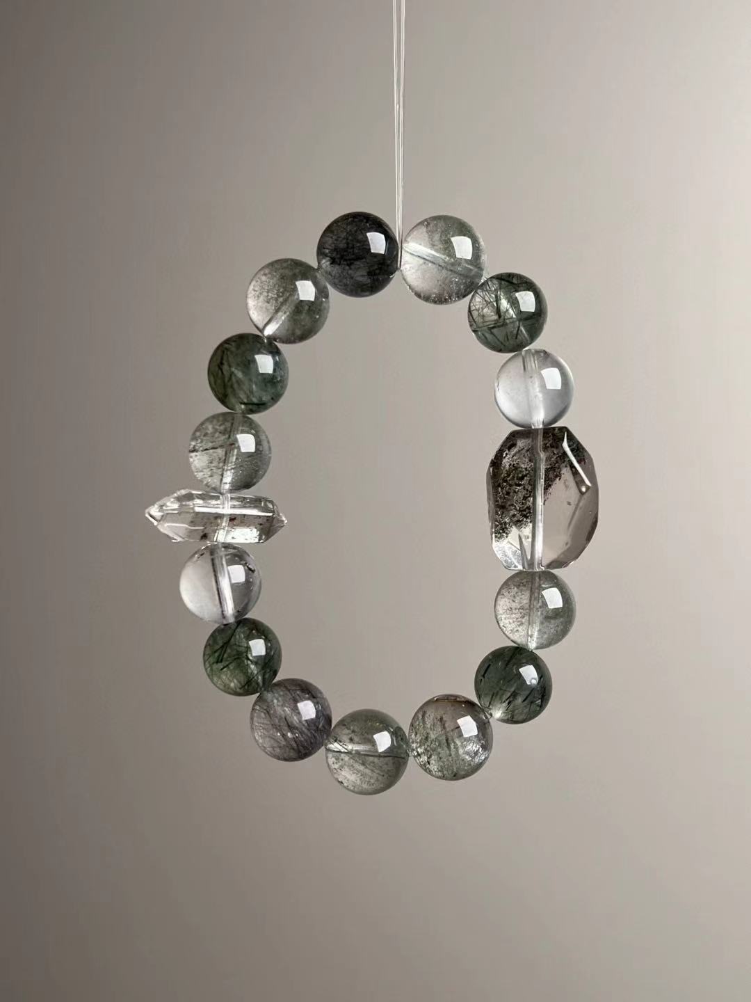 Angled hero—visible phantom inclusions and a faceted smoky-clear focal with a double-terminated quartz spacer