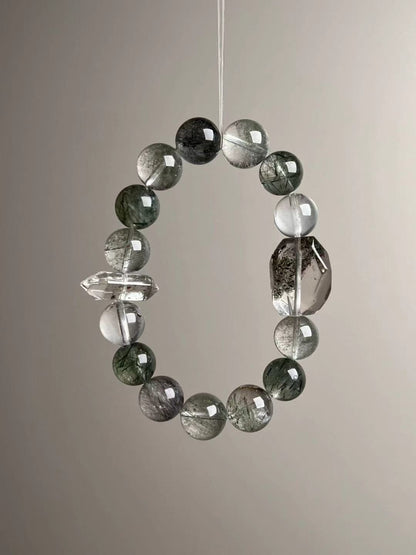 Angled hero—visible phantom inclusions and a faceted smoky-clear focal with a double-terminated quartz spacer