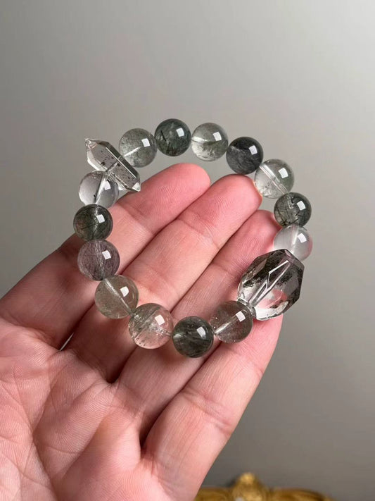 On-hand photo—≈12.5 mm bracelet with Green Phantom Quartz, Black Flash Quartz, Green & Black Rutilated Quartz, and a double-terminated quartz accent