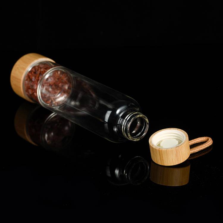 Bottle laid on side showing bamboo cap with food-grade gasket and isolated chip chamber at the base