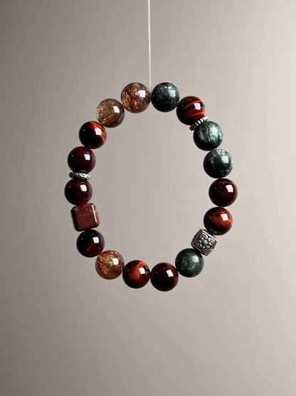 Angle shot showing the balance of red tiger’s eye, feathery seraphinite and sparkling phantom quartz accents.