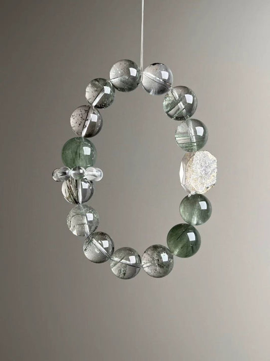 Angled hero—close view of dark and light Green Phantom inclusions and a double-terminated Herkimer-style quartz accent