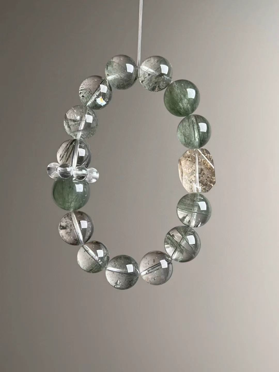 Angled hero—Green Rutilated Quartz needles and translucent Green Phantom spheres, 12–13.5 mm.