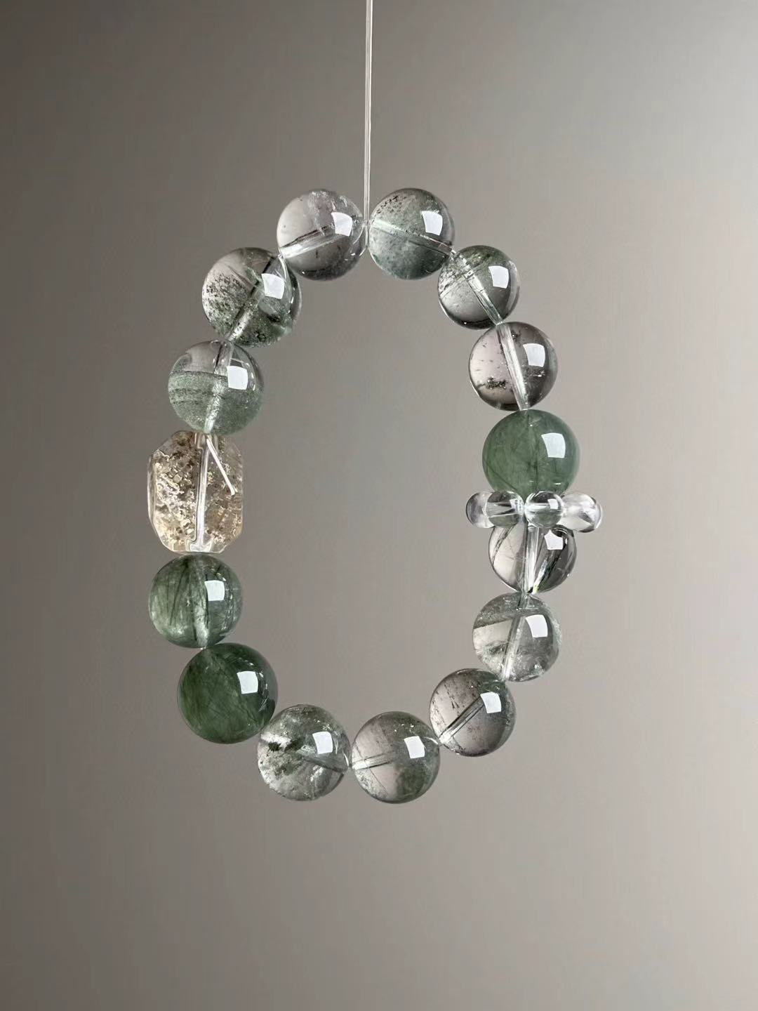 Front hero—Emerald Resonance Matrix bracelet showing mixed Green Phantom Quartz rounds with clear-quartz bead-cluster and faceted focal