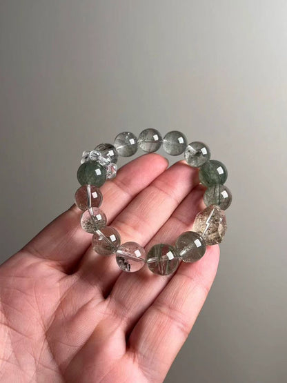 On-hand photo—12–13.5 mm bracelet with Green Phantom Quartz, Herkimer quartz point, Green Rutilated Quartz and a clear-quartz bead-cluster spacer