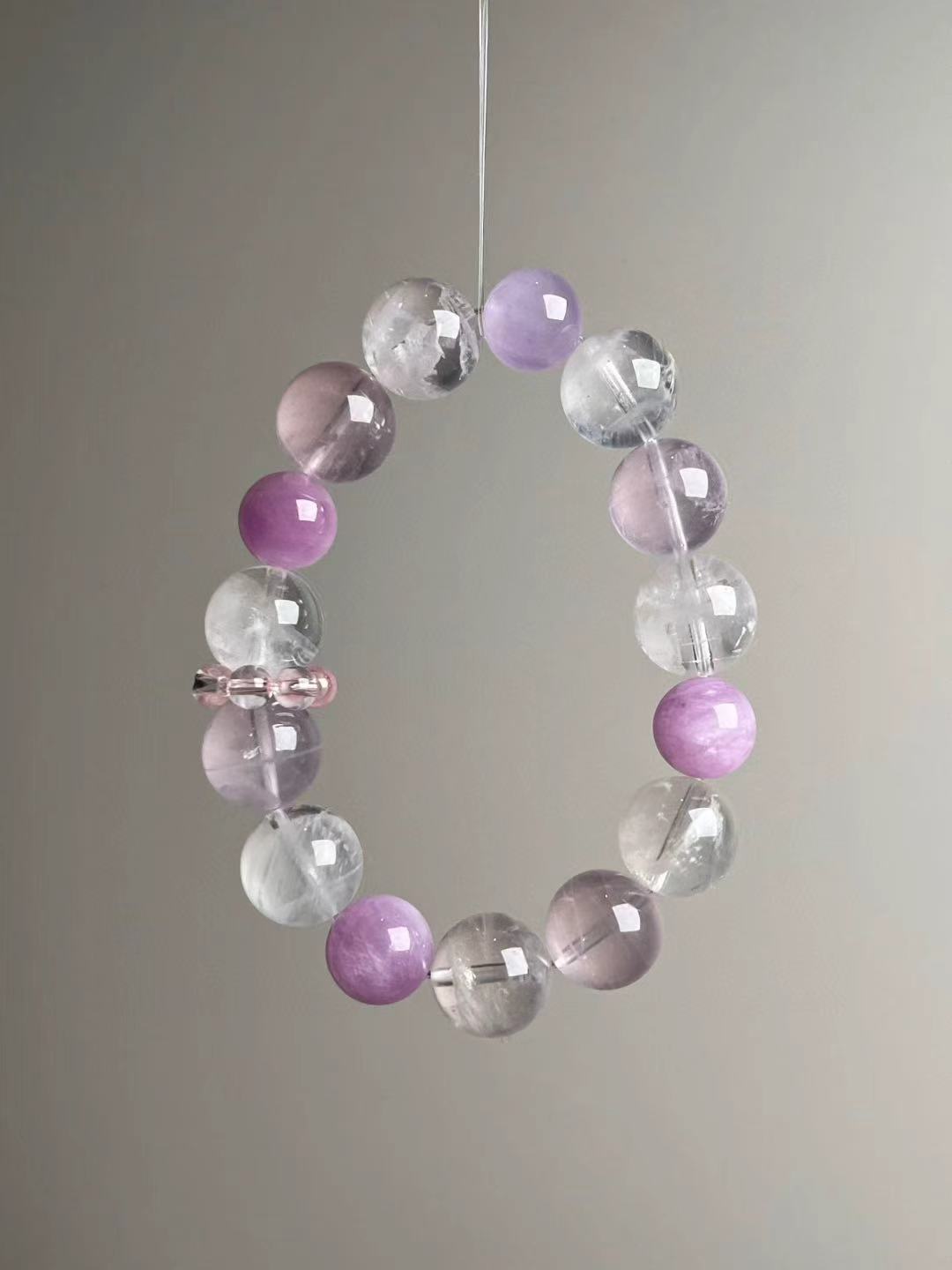 Detail—pink bead cluster spacer on Rose Quartz, White Phantom Quartz and Lepidolite bracelet