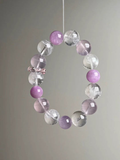 Front hero—Rose Quartz, White Phantom Quartz and Lepidolite 14–11 mm bracelet on grey background