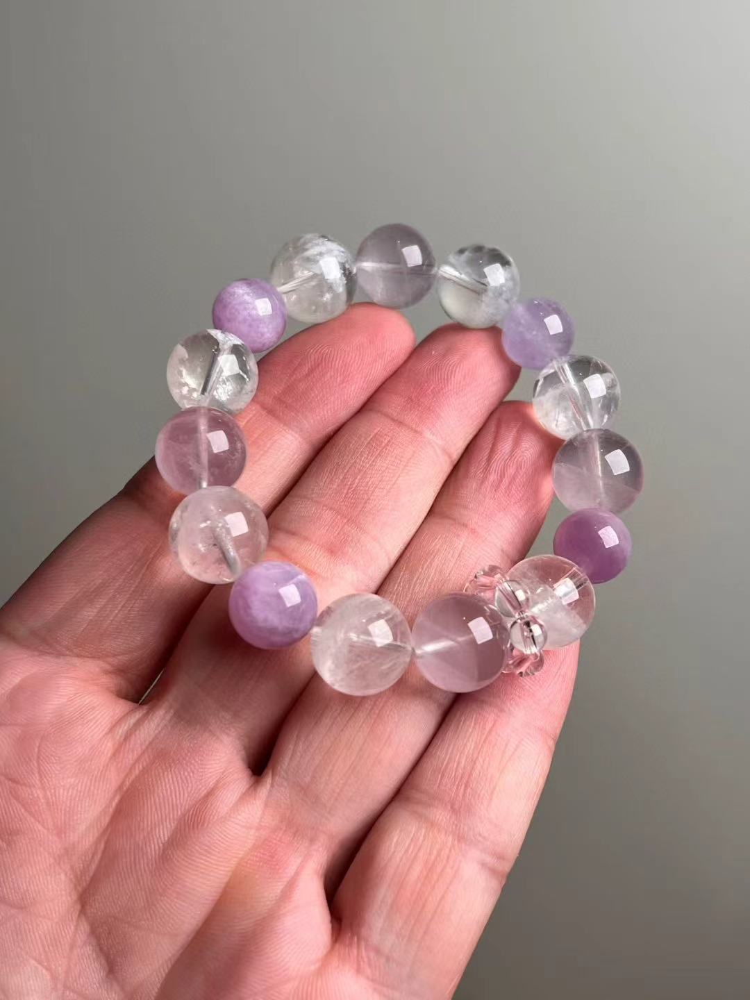 On-hand photo—14–11 mm Rose Quartz, White Phantom Quartz and Lepidolite bracelet with pink bead-cluster spacer.
