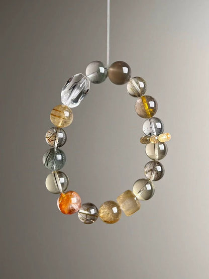 Macro texture—polished Gold Rutilated Quartz, Black-Gold Super Seven, Green Phantom and Clear Quartz beads, 12–10.5 mm