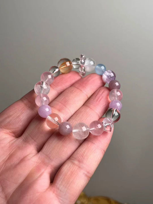 On-hand photo—13–9 mm bracelet with rose quartz double-terminated bead, lepidolite, white azeztulite, white phantom quartz and aquamarine accents