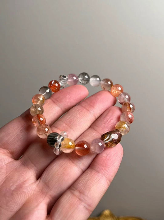 On-hand photo—≈9 mm Yellow Phantom, Rose Quartz, Koi Flower resin accents, Black Rutilated & Clear Quartz bracelet