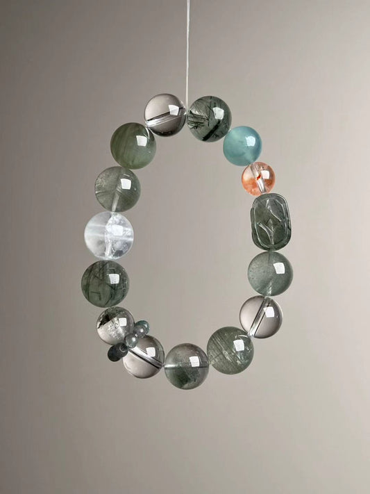 Angled hero—teal Apatite runner ring near Clear Quartz; steady mix of Green Rutilated Quartz and Green Phantom beads