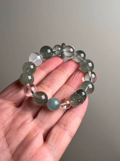 On-hand view—15–10 mm Green Rutilated Quartz Pixiu bracelet with Aquamarine, Clear Quartz, Green/White Phantom and teal Apatite bead-cluster ring