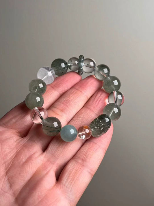 On-hand view—15–10 mm Green Rutilated Quartz Pixiu bracelet with Aquamarine, Clear Quartz, Green/White Phantom and teal Apatite bead-cluster ring
