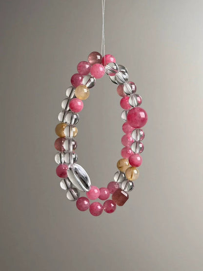 Full loop display—slender profile of the bracelet showing Clear Quartz oval focal and evenly spaced pink gemstones
