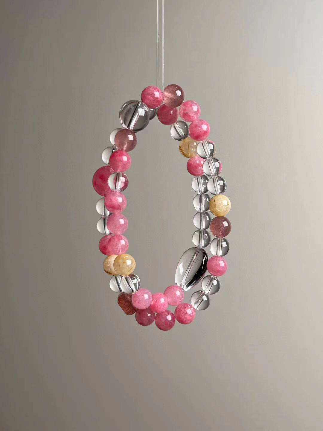 Macro texture—polished Clear Quartz, Rose Quartz, Golden Rutilated Quartz and Strawberry Quartz beads, 11.5–7 mm