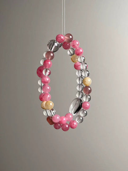 Macro texture—polished Clear Quartz, Rose Quartz, Golden Rutilated Quartz and Strawberry Quartz beads, 11.5–7 mm