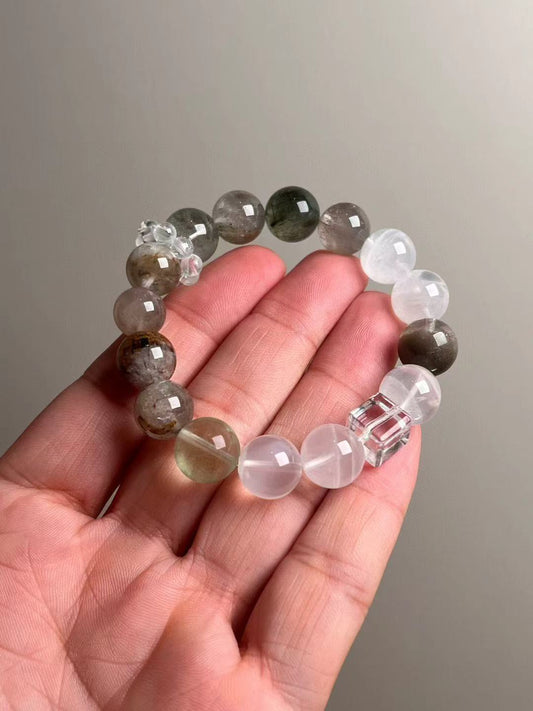 Hand shot of the Purity Circuit bracelet, 12–13 mm multi-gem rounds with clear-quartz cube accent.