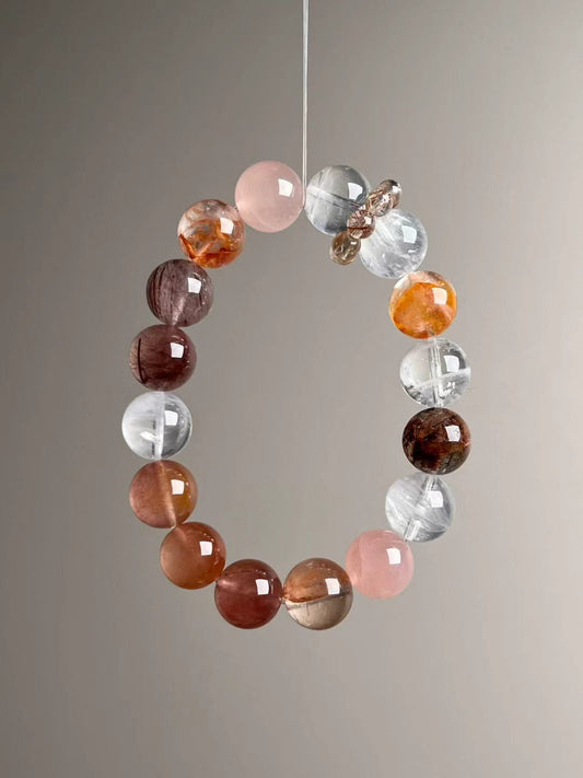 Front hero—Purity & Momentum Matrix bracelet showing pink Rose Quartz and clear to smoky quartz tones with rutile needles, 12 mm
