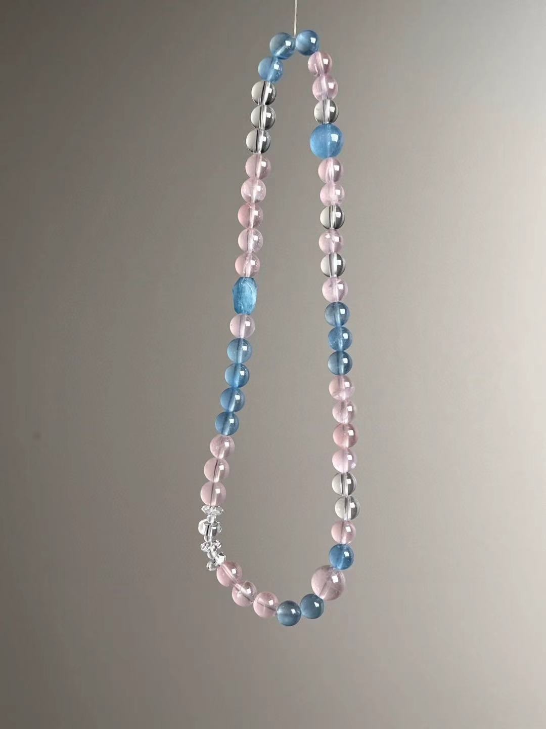 Full-length layout of the double-wrap strand with clustered clear-quartz accents near the focal zone.