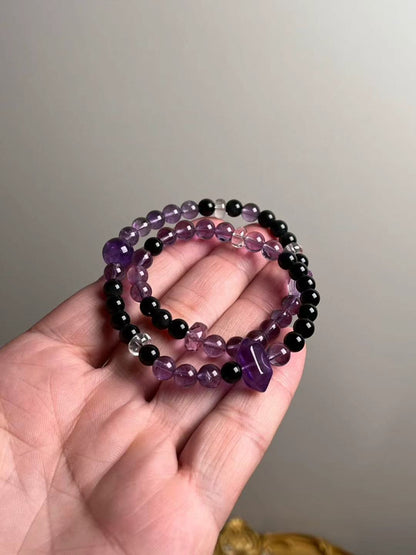 Hand shot of double-wrap bracelet — Amethyst with double-terminated focal, obsidian accents and clear quartz spacers (10.5–7 mm)