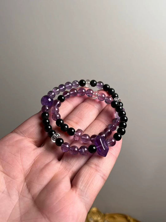 Hand shot of double-wrap bracelet — Amethyst with double-terminated focal, obsidian accents and clear quartz spacers (10.5–7 mm)