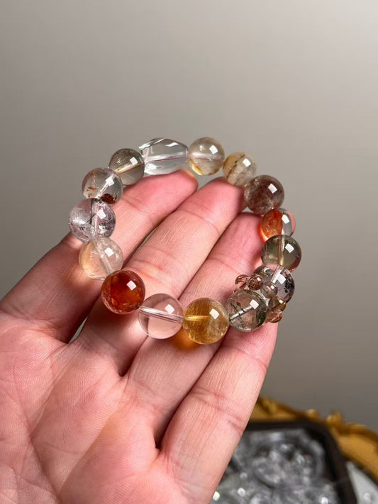 In-hand scale: Clear Quartz, Golden Rutilated Quartz & Yellow Azeztulite bracelet (13.5–11 mm) with copper rutile spacer.