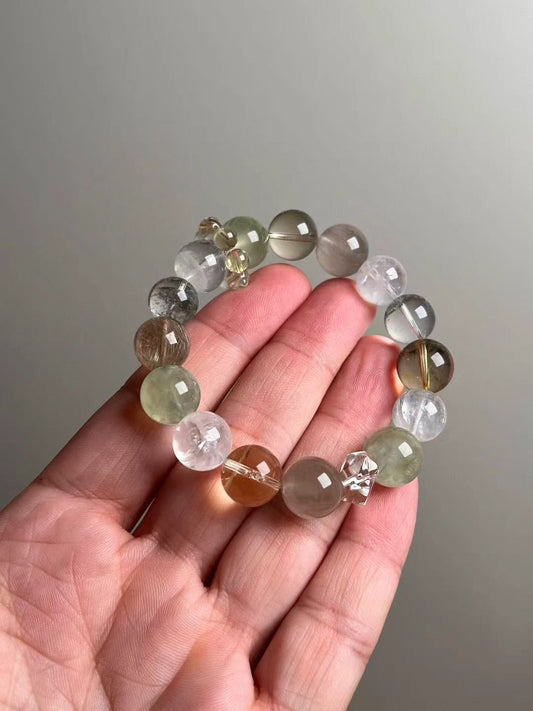 Bracelet on hand — mixed 10.5–12 mm beads for scale.