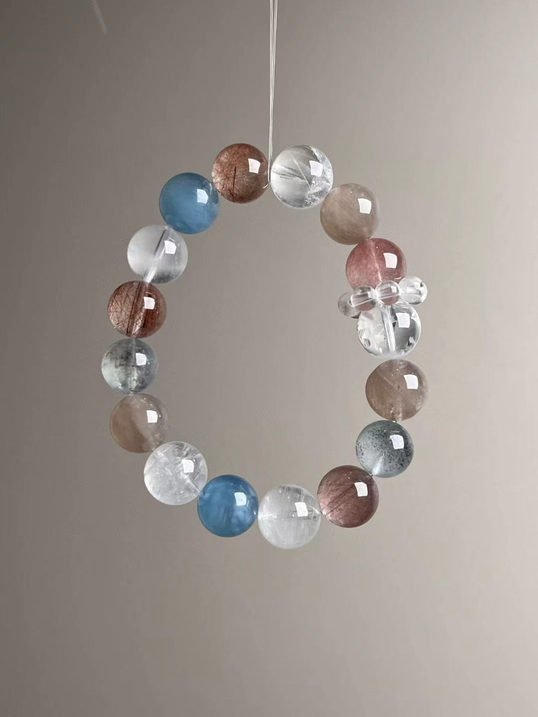 White Phantom garden quartz beads with aquamarine accents—angled view