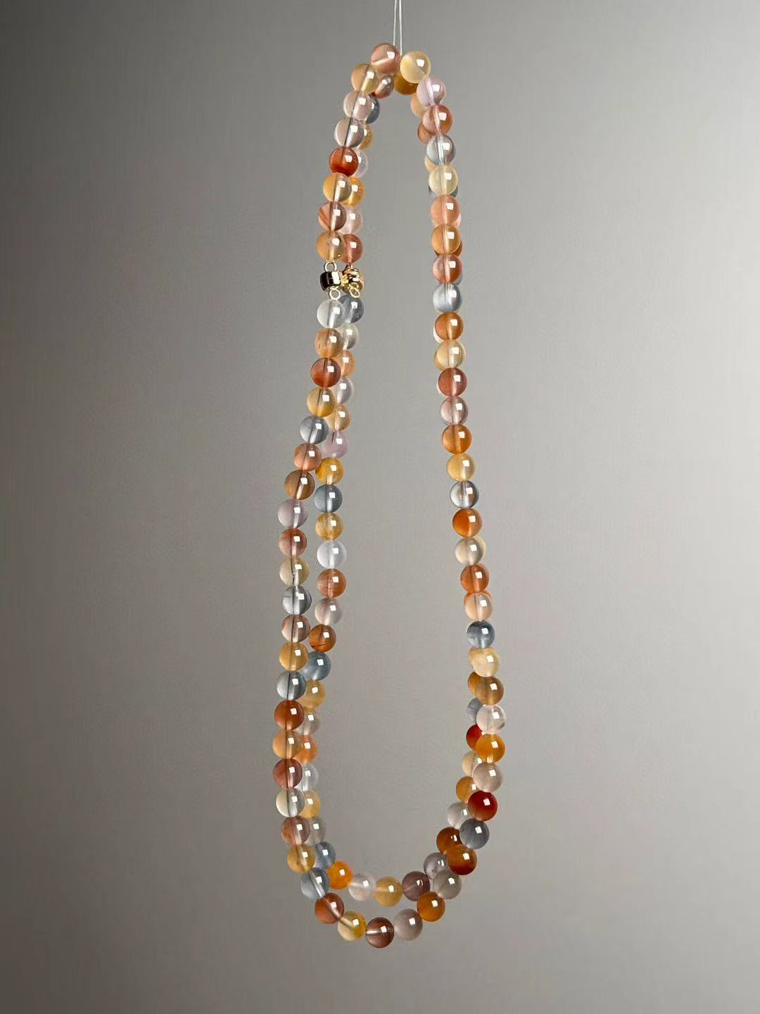 Lunar Xue multigem rabbit-hair quartz necklace; front hanging view with soft pastels