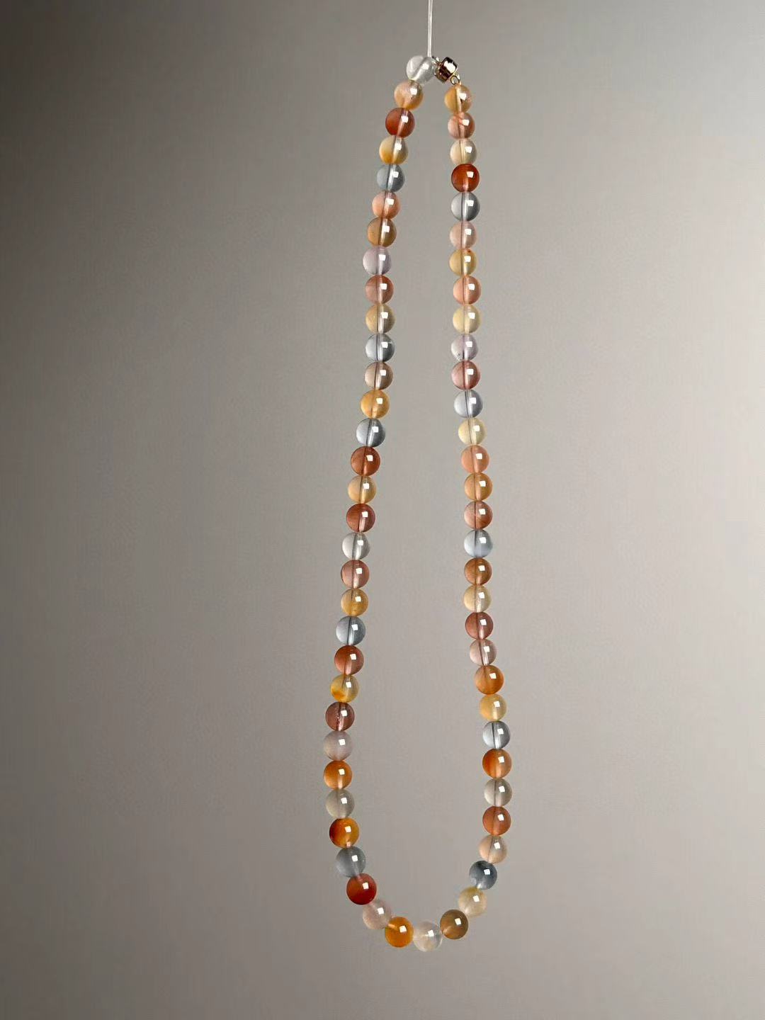 Detail of translucent beads; balanced mix of blush, amber and grey-blue hues