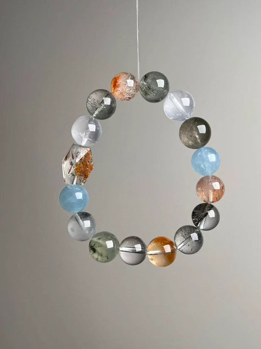 Detail of rutilated quartz and orange moonstone beads with polished luster and clean drill lines.