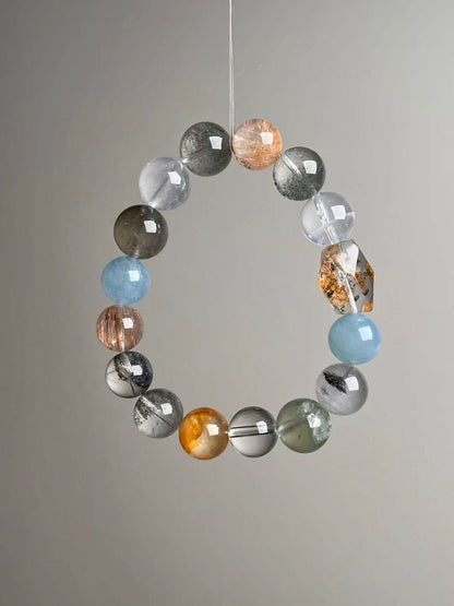 Side view showing double-terminated yellow citrine-style focal and balanced gray–blue–gold palette