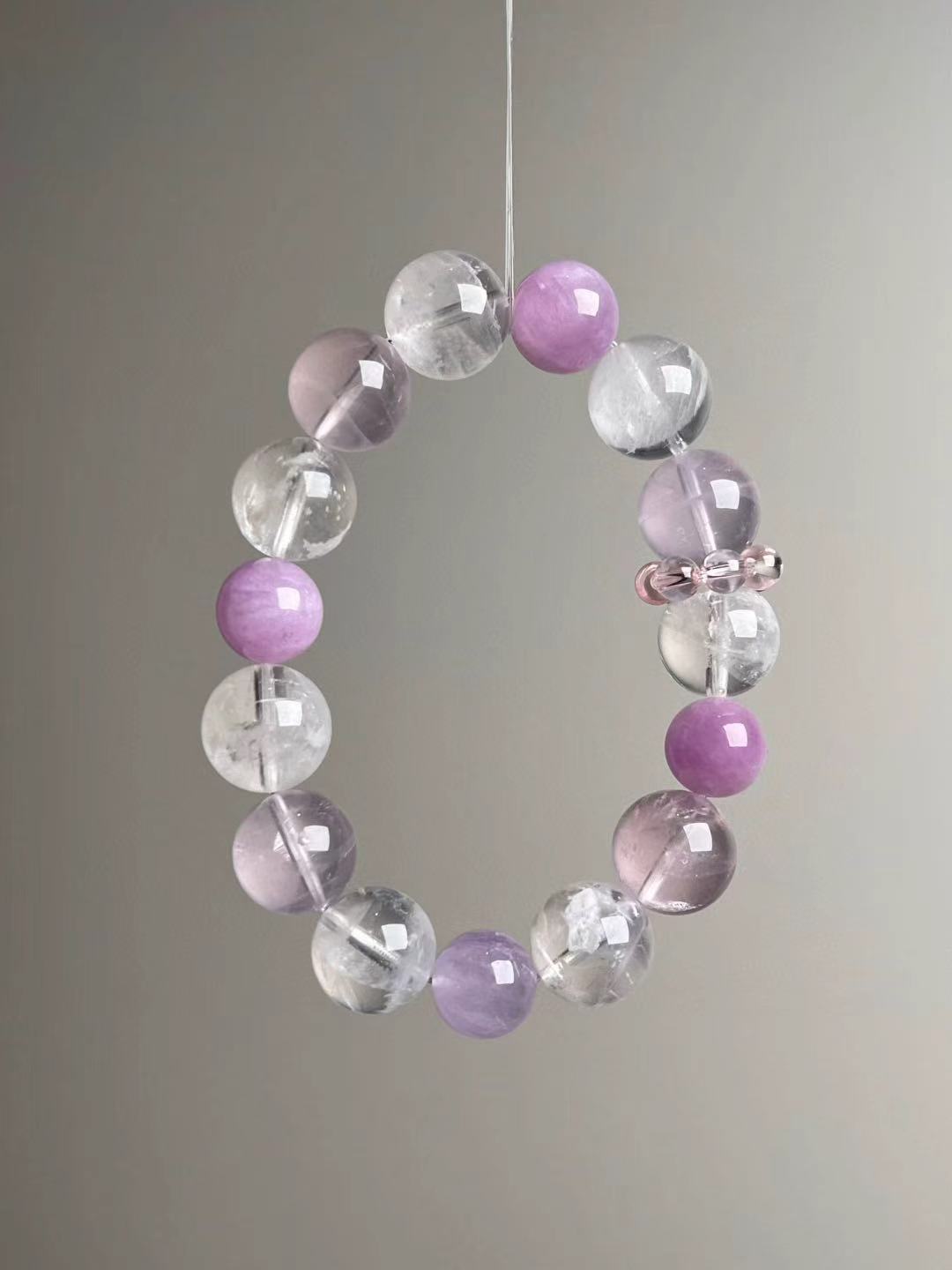 Angled hero view highlighting soft pink Rose Quartz, lilac Lepidolite and clear White Phantom beads, 14–11 mm