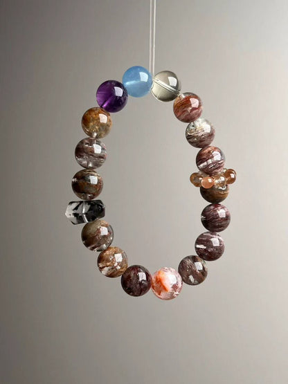 Seven-Spectrum Guardian bracelet flat lay showing orange-snow phantom beads