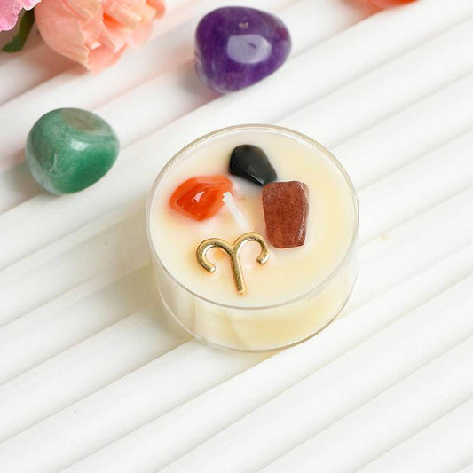 Aries gemstone tea-light candle close-up with carnelian, red goldstone and dark protective stone plus Aries charm.